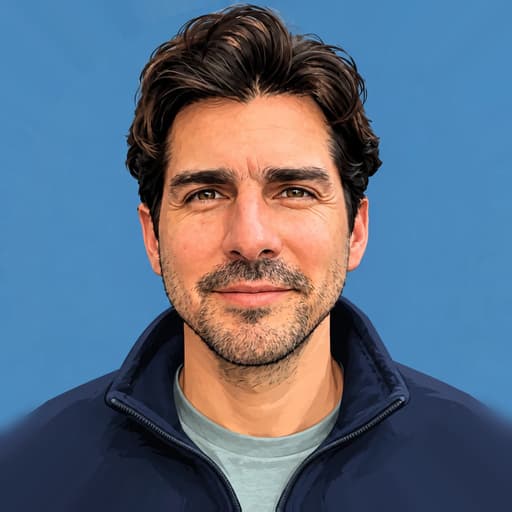 Daniel Echeverri, a dark-haired man with a short beard, smiling in a navy jacket against a blue background